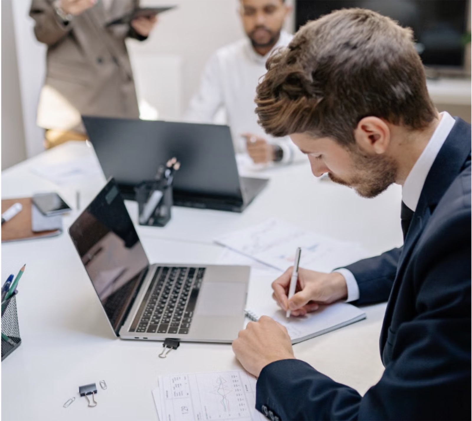 Compliance specialist preparing filing notes at a modern desk