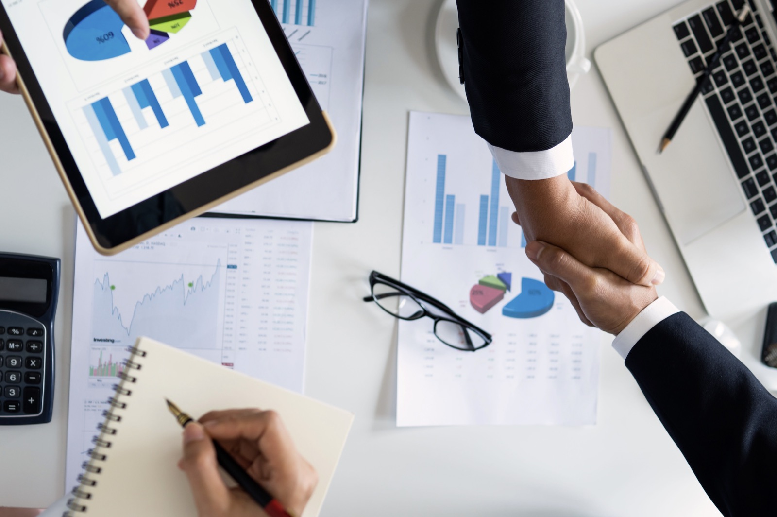 Professionals closing a compliance engagement over financial documents
